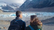 Travelers couple look at the mountain lake. Adventure and travel in the mountains region Patagonia, Fitz roy Mountain. 4k
