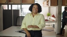 Portrait of African American business woman smiling with confidence in corporate management professional at work
