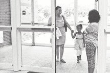 greeter welcoming a mother and daughter 