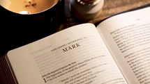 Rack focus on Bible open to the Gospel of Mark