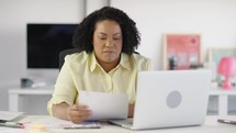 Woman upset at desk do accounting job or manage personal finances, reviewing bills.
