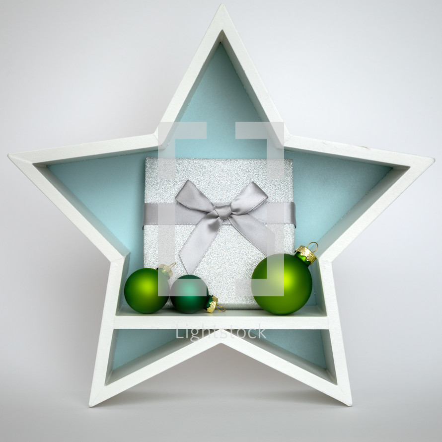 Green Christmas ornaments and gift in a star 