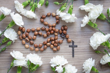 white carnations and rosary beads 