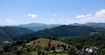 Small Village At The Valley Of Apuseni Mountain Range Of Western Romanian Carpathians. aerial