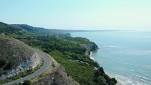 Asphalt Road On Rugged Shoreline Of Heros Beach In The Town Of Balchik, Black Sea Coast, Bulgaria. aerial