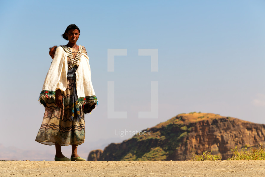 a woman standing in the desert of Ethiopia 