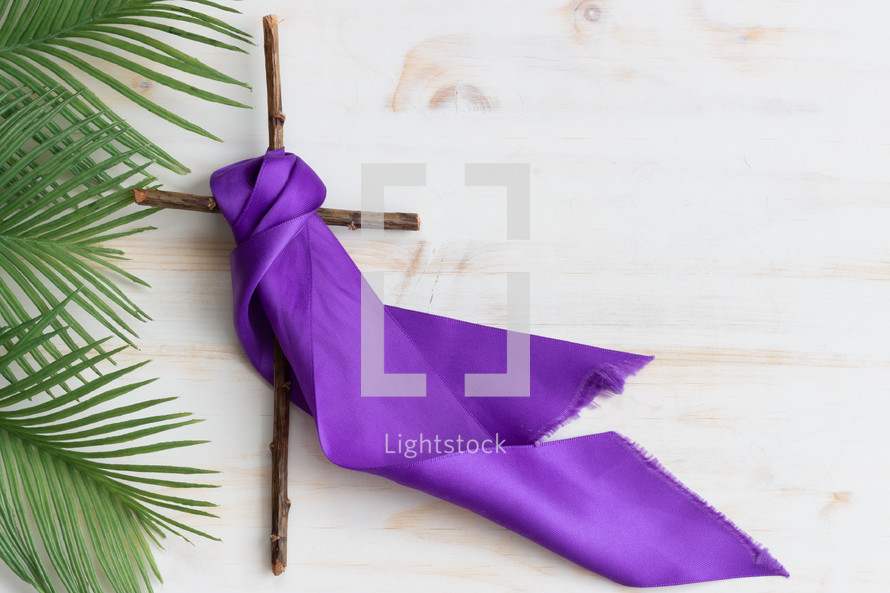 palm fronds, cross, and purple sash 
