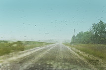 country road through wet windshield 