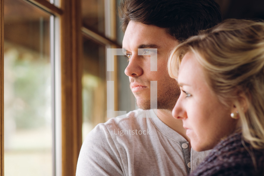 couple looking out a window 