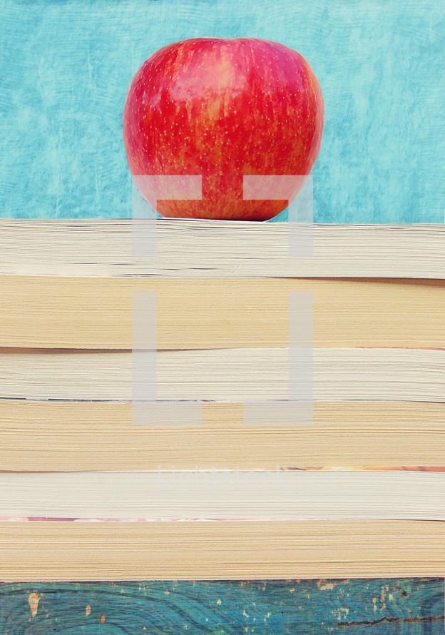 A stack of books with an apple on top.