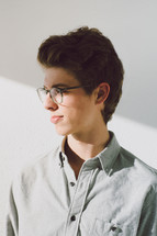 side profile of a young man in glasses 