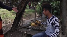 Young asian person selling bananas