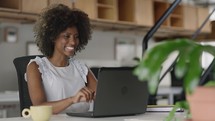 Young black business woman communicating by video call. Ethnic businesswoman speaking looking at laptop computer, online conference distance office chat, virtual training
