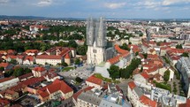 Aerial shot drone flies over Trg bana Josipa Jelačića toward Cathedral of Zagreb in Croatia