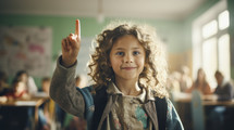 Back to school concept. Portrait of caucasian school girl raising hand in classroom.