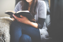 an Asian woman reading a Bible 