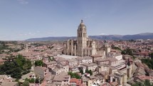 Segovia Cathedral in Spain on a sunny day, establishing aerial, circling	