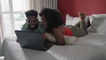 Young couple using laptop computer together
