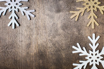 snowflake ornaments on a wood background 