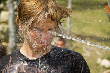 water sprayed in a teen's face