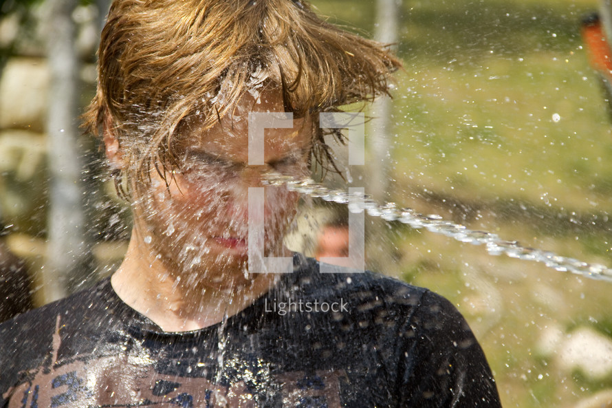 water sprayed in a teen's face