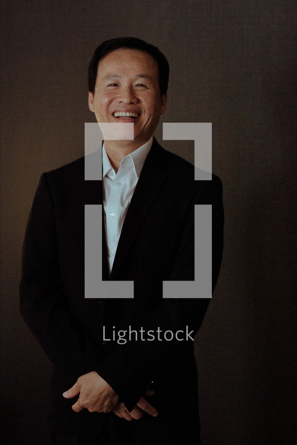 smiling Asian man posing for a portrait 