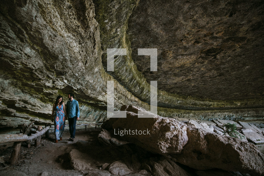 couple walking in a cave 
