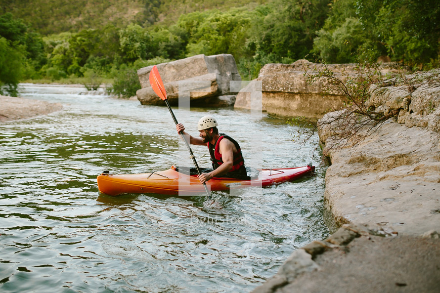man paddling in a kayak 