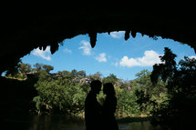 silhouette of a couple in a cave 