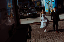 bride and groom on a cobblestone street 