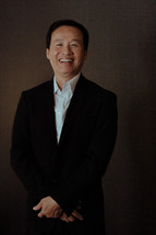 smiling Asian man posing for a portrait 
