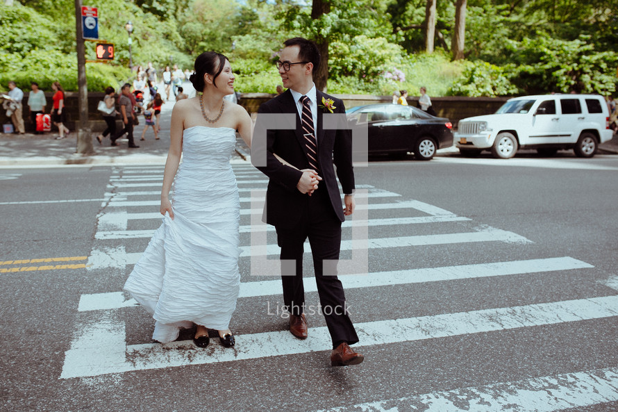 bride and groom on a cross walk 