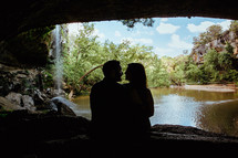 silhouette of a couple in a cave 