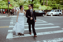 bride and groom at a crosswalk 