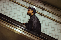 man walking up stairs in a subway 