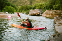 man paddling in a kayak 
