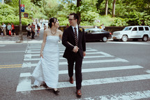 bride and groom on a crosswalk 