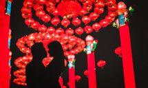 couple embracing under Chinese lanterns - decorations