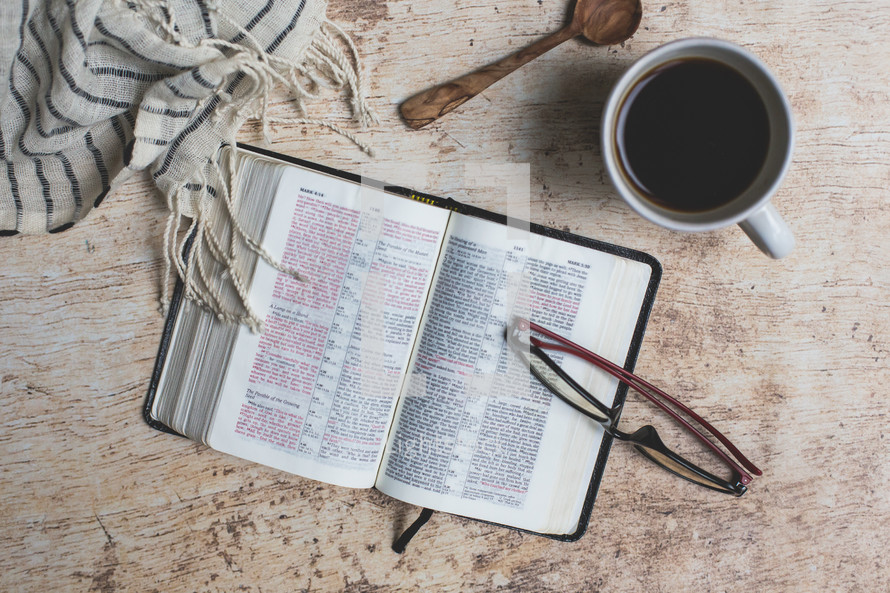 open Bible with coffee mug and scarf 