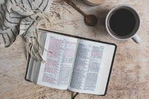 open Bible with coffee mug and scarf 
