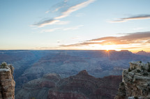 sun setting behind a canyon 