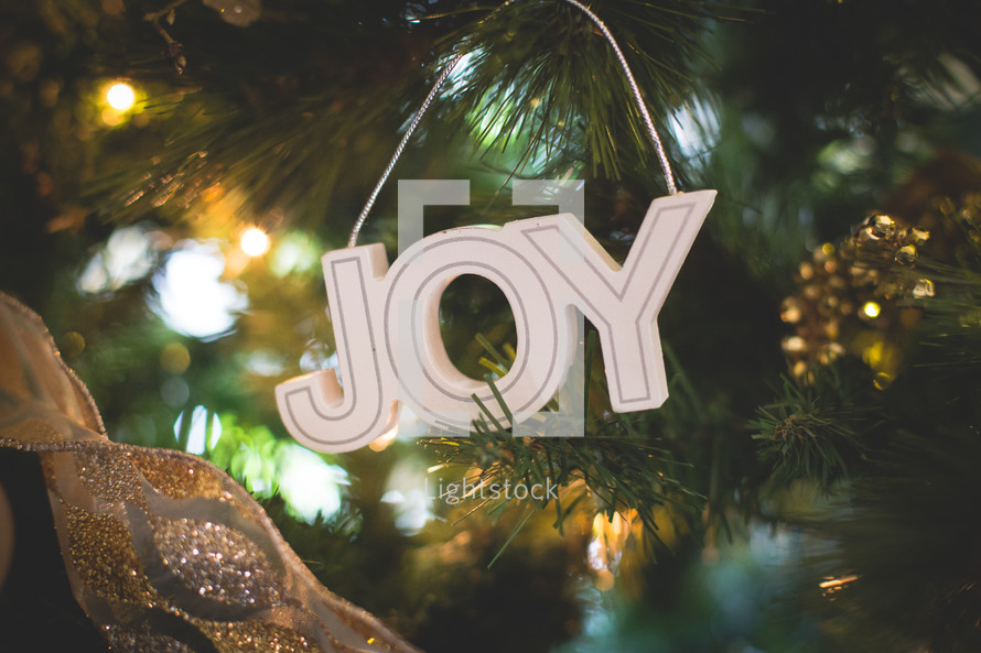 Joy Christmas ornament on a Christmas tree