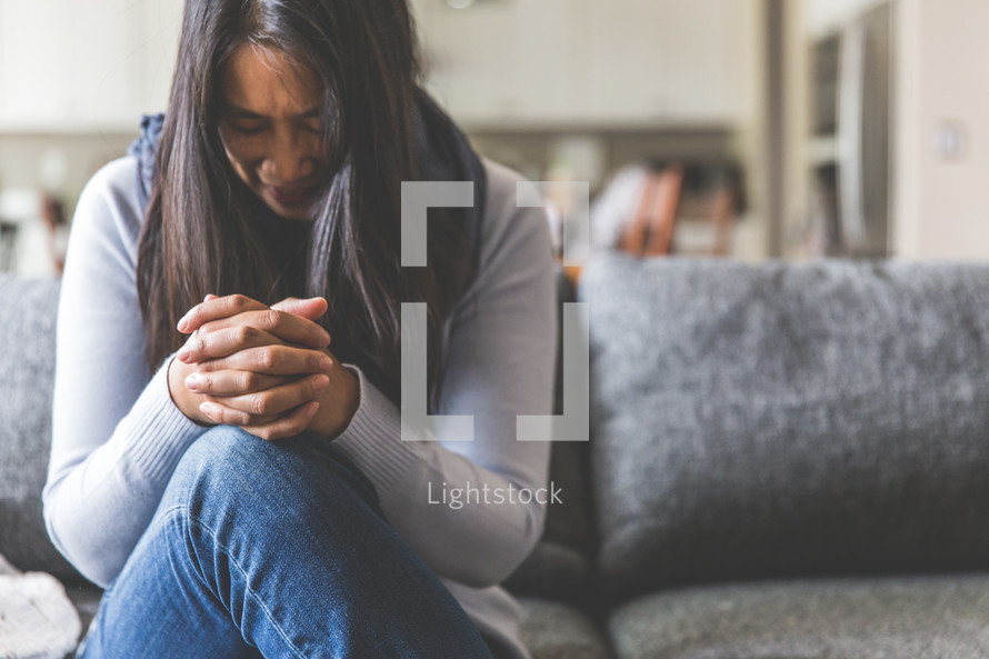 a distressed woman praying 