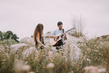 a man serenading a woman outdoors 
