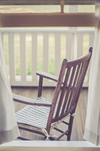 wood rocking chair on a front porch 