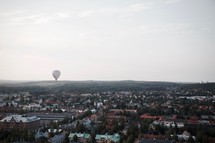 hot air balloon over a neighborhood 