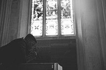 man seeking forgiveness in a church