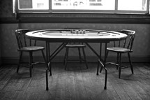 A poker table and chairs.