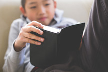 A boy reading a Bible 