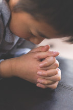 A boy child in prayer
